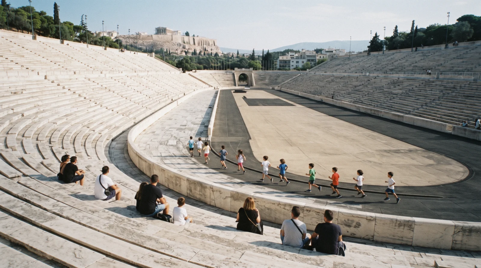 Children running on the marble track of the Panathenaic Stadium, Athens with kids, Greece