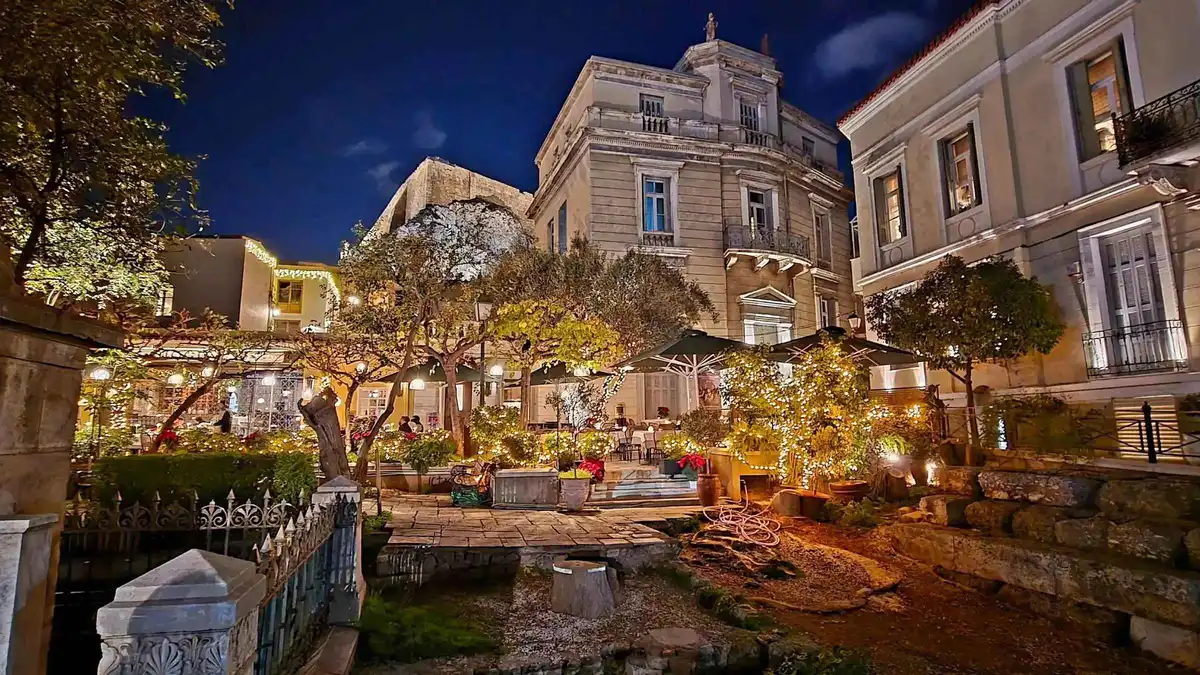 Lit lanes of Plaka below the Acropolis on a night walking tour in Athens, Greece
