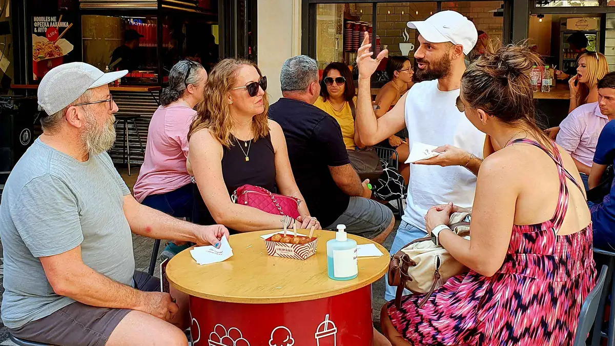 A souvlaki counter with skewers on the grill on an Athens street food tour in Greece