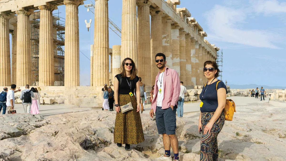 A guide with a small group on the Acropolis in the first hour of the morning in Athens, Greece