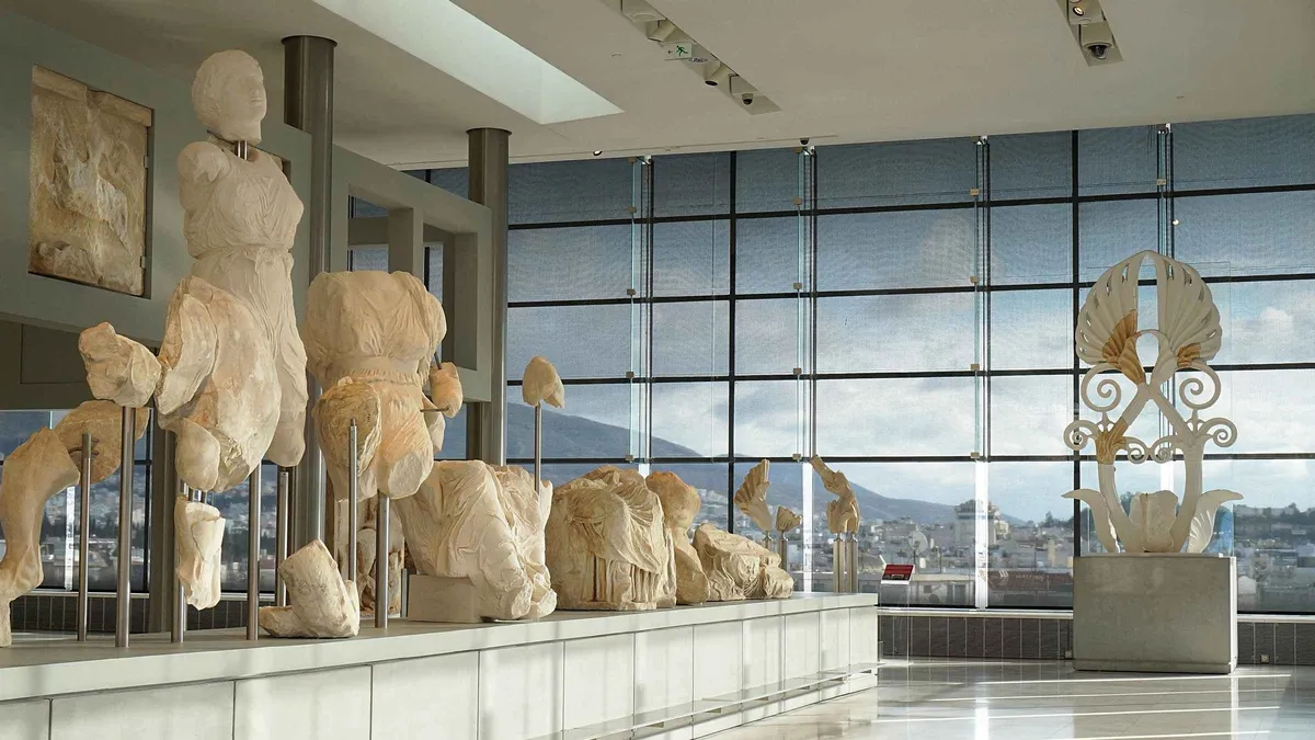 Visitors on the glass floor above the excavated street inside the Acropolis Museum in Athens, Greece
