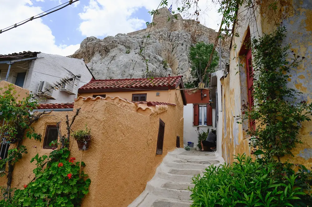 Whitewashed island houses and steps of Anafiotika under the north face of the Acropolis rock, Athens, Greece