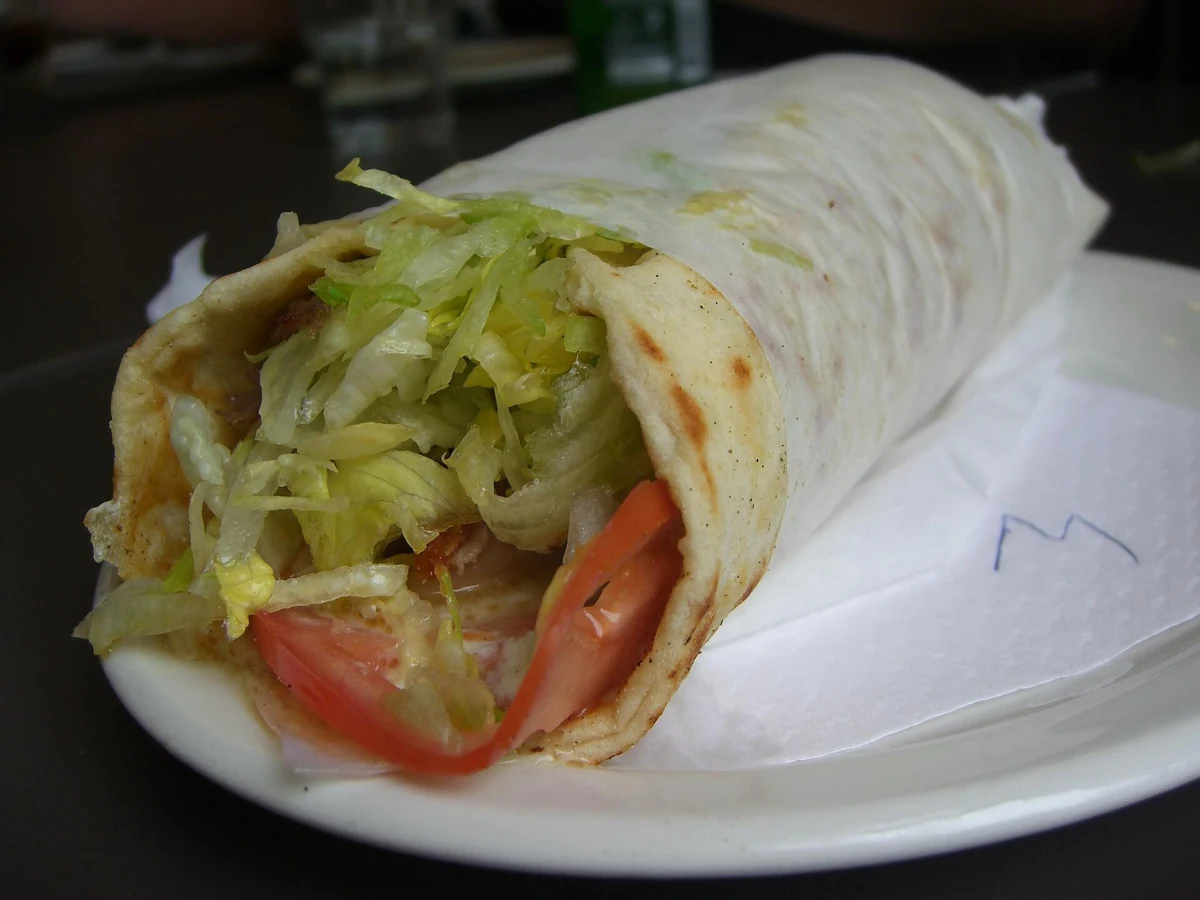 A souvlaki wrapped in pita and paper, the everyday cheap meal in Athens, Greece