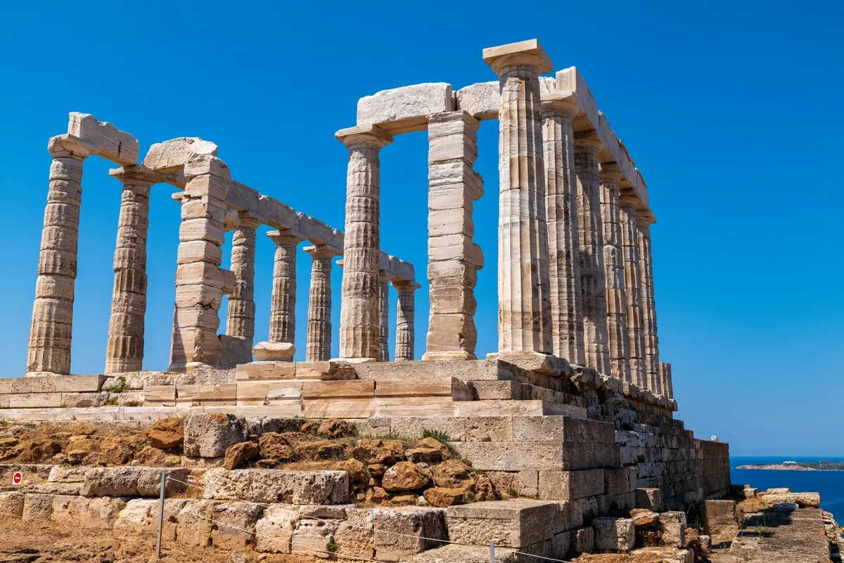 The standing columns of the Temple of Poseidon above the sea at Cape Sounion, a day trip from Athens, Greece